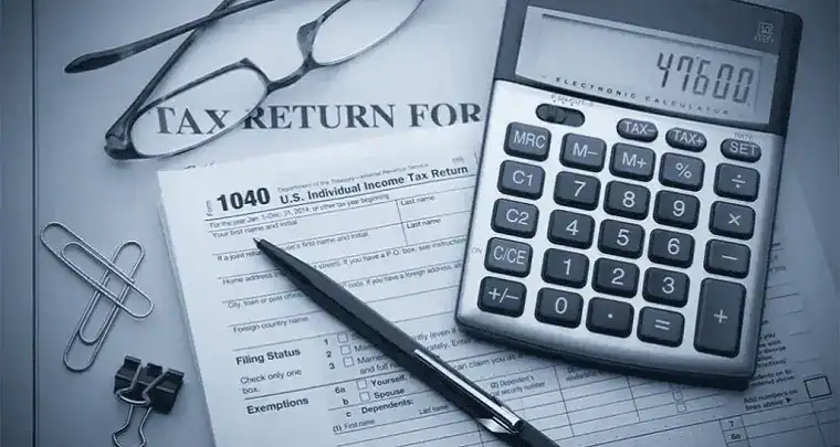 Tax return document with calculator and office supplies highlighting financial and tax filing services offered by ICT.
